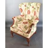 An Early 20th Century Barrel Back Armchair with Scroll Carved Arms, raised upon cabriole legs with