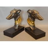 A Pair of Patinated Metal Bookends in the form of greyhound heads on rectangular plinths, 22cm tall