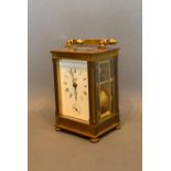 A French Brass Cased Carriage Clock retailed by Dent, London, the enamel dial with Roman numerals