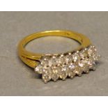 An 18 Carat Yellow Gold and Diamond Ring set with three rows of diamonds within a pierced setting