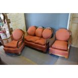 An Early 20th Century Walnut Three Piece Bergere Suite comprising three seater sofa and a pair of