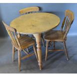 A Pine Circular Table with Turned Legs, together with three pine stickback chairs