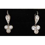 A Pair of 18ct White Gold Diamond Drop Earrings, each set with a group of three diamonds on a