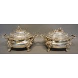 A Pair of George III Silver Covered Tureens, each with a foliate mount, the bases with two handles