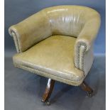 A 19th Century Green Leather and Brass Studded Revolving Office Chair raised upon outswept legs with