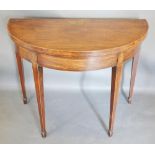 A 19th Century Mahogany Demi Lune Card Table, the marquetry inlaid and crossbanded top enclosing a