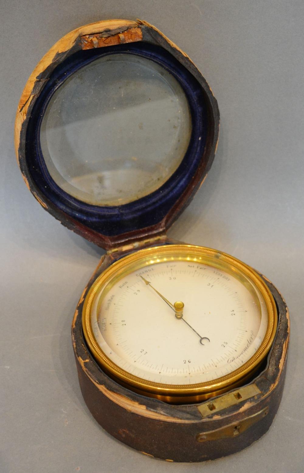 A Late 19th/Early 20th Century Brass Aneroid Barometer within original case bearing label