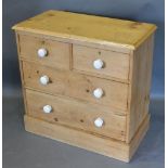 A Pine Small Chest, the moulded top above two short and two long drawers with ceramic knob handles