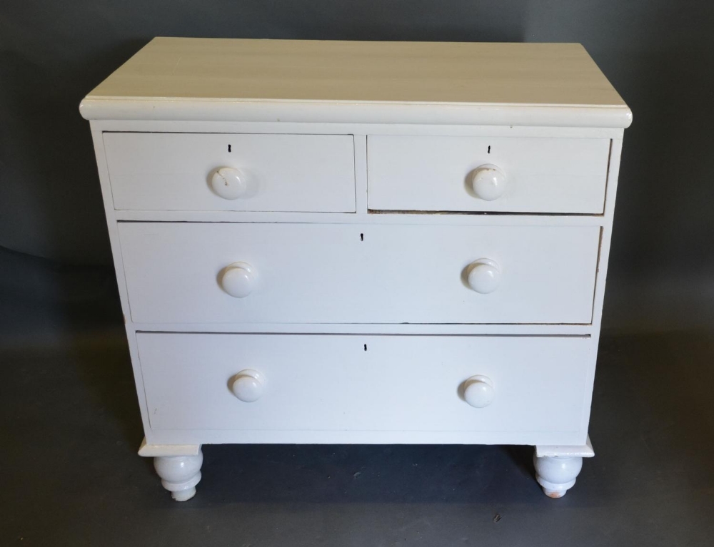 A 19th Century Painted Pine Chest of two short and two long drawers with knob handles raised upon