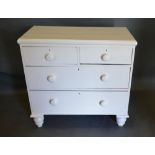A 19th Century Painted Pine Chest of two short and two long drawers with knob handles raised upon