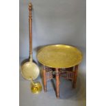 A Benares Brass Tray on Folding Wooden Stand, together with a brass chamber stick and a brass