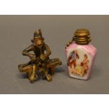 A Small Bronze Model of a Monkey Sitting on a Bench Smoking a Pipe, together with a small