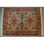 A Russian Mikrah Woollen Rug with an allover design upon a cream and red ground within multiple