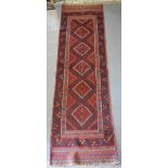 A North West Persian Wool Runner with an allover design upon a red and blue ground within multiple