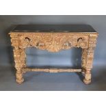 A Gilded and Painted Console Table by Kathleen Spiegelman, the black marble top above a carved
