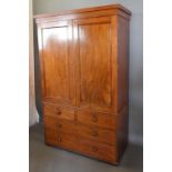 A 19th Century Mahogany Linen Press, the moulded cornice above two panelled doors enclosing