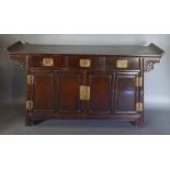 A Chinese Hardwood Altar Table with an arrangement of three drawers above two panelled doors flanked