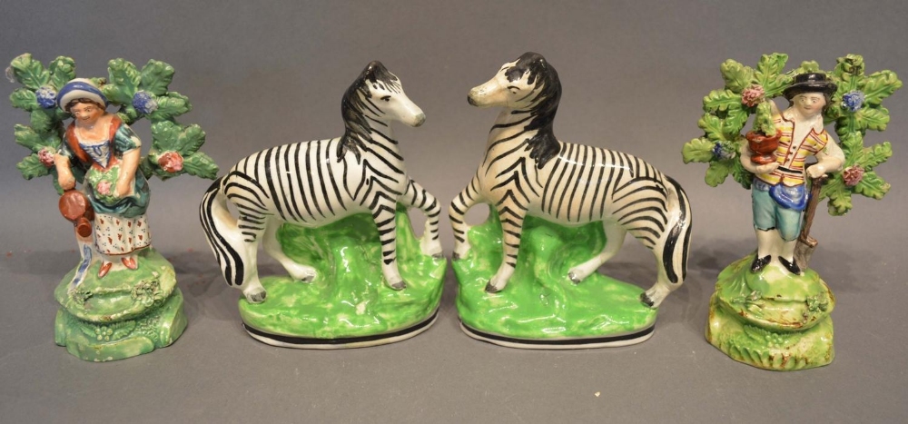 A Pair of 19th Century Staffordshire Models in the form of zebra, together with a pair of early 19th