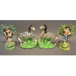 A Pair of 19th Century Staffordshire Models in the form of zebra, together with a pair of early 19th