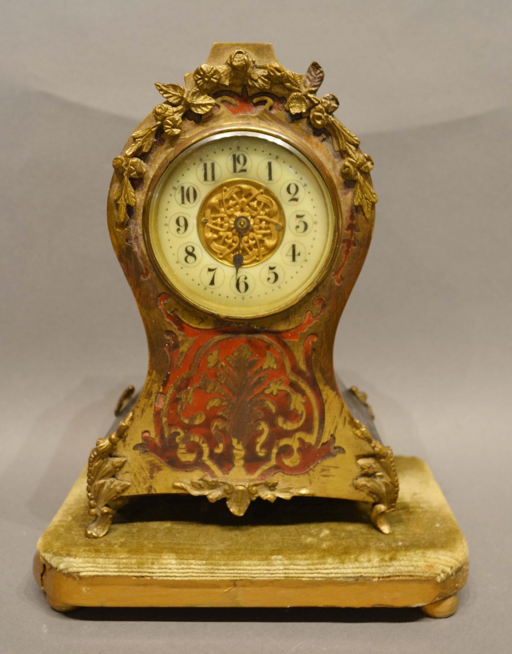 A 19th Century Boulle Mantel Clock, the enamelled dial with Arabic numerals upon a gilded and fabric