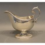 A George III Silver Sauce Jug With Oval Pedestal Base And Shaped Handle, London 1784, makers mark SI