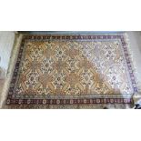 A North West Persian Woollen Rug with an allover design upon a pale cream and red ground within