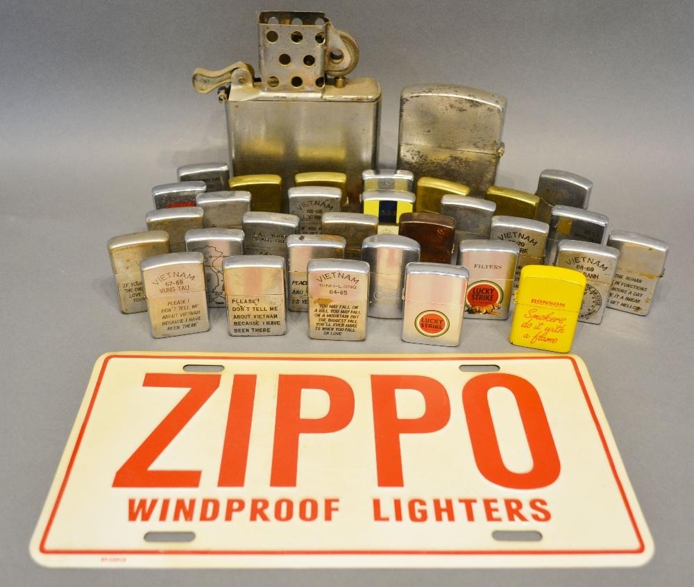 A Large Collection of Zippo Lighters, together with a collection of other similar lighters