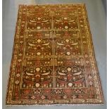 A North West Persian Woollen Rug with six panels within an allover design upon a blue, cream and red