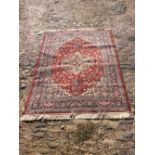 A North west Persian Woollen Rug, with all over design upon a red and cream ground, 200cm by 141cm