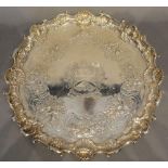 A George III Silver Salver of Shaped Outline with three pierced scroll feet and with central