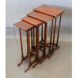 A Mahogany Quartetto Nest of Occasional Tables with slender reeded legs and outswept feet