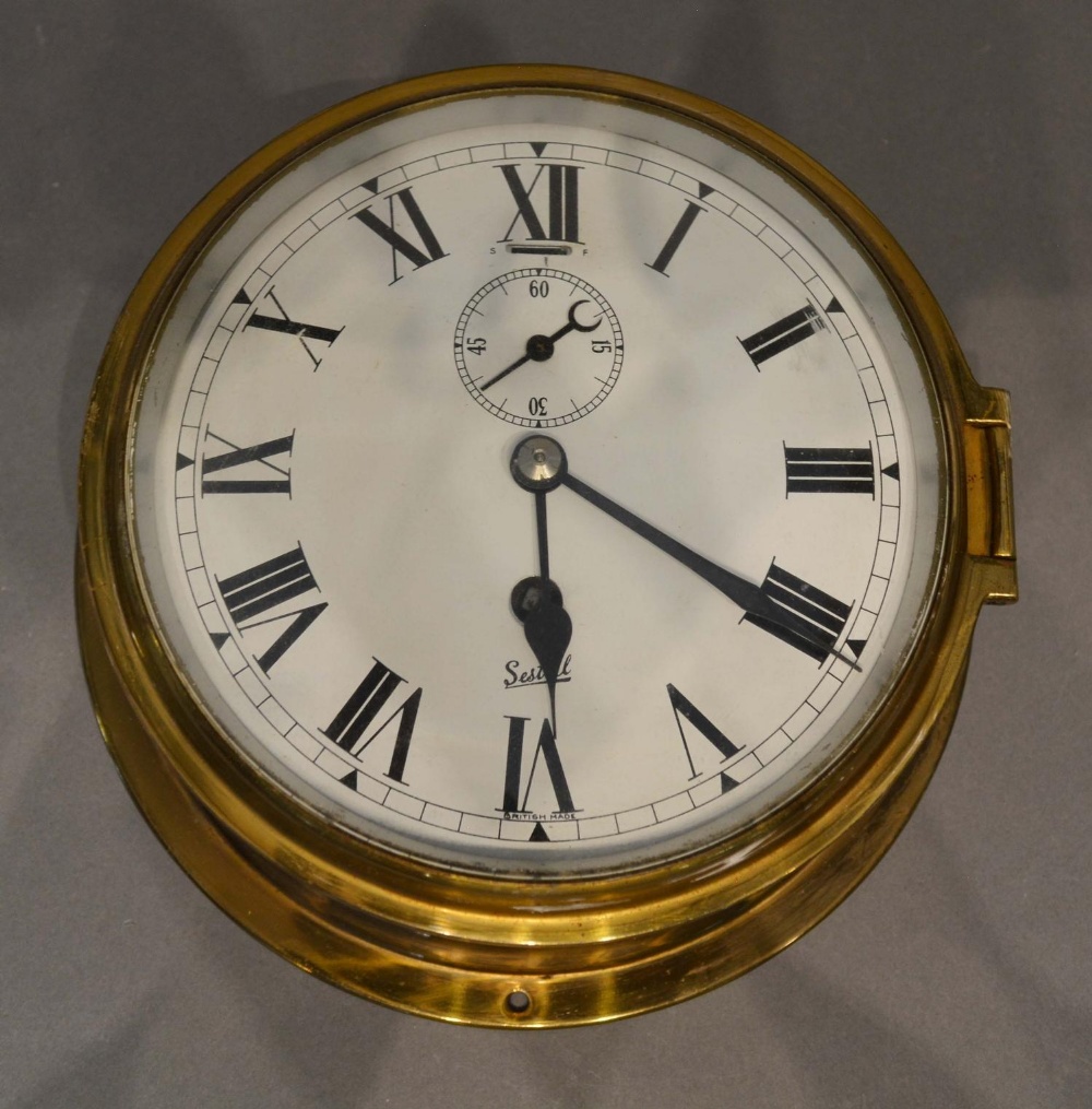 A Circular Brass Ship's Clock by Sestrel, 18cm diameter