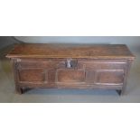 An 18th Century Oak Small Coffer, the hinged top above a three panelled front flanked by stiles with