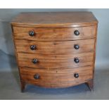 A 19th Century Mahogany Bow-Fronted Chest of four long drawers with knob handles raised upon