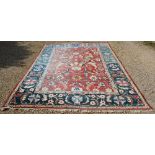 A Ziegler Woollen Carpet with an allover design upon a red, cream and blue ground within multiple