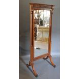 An Edwardian Mahogany Cheval Mirror with half turned reeded pilasters and outswept legs with brass
