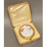 A Large Oval Cameo set in yellow metal, the carved cameo depicting two classical females and two