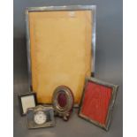 A Birmingham Silver Rectangular Photograph Frame, 30 x 20cm, together with three smaller silver