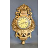A Carved Giltwood Cartel Clock, the dial with Arabic numerals and two train movement, 62 cms long