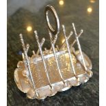 An Edwardian Silver Plated Four Division Toast Rack in the form of golf clubs and balls