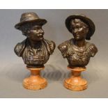 A Pair of Patinated Bronze Busts depicting a lady and gentleman, raised upon shaped marble