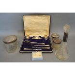 A Silver Part Manicure Set within fitted case, together with four silver mounted dressing table jars
