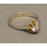 A White Gold Solitaire Diamond Ring with a single diamond mounted in an unusual pierced setting