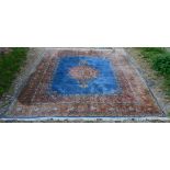 A North West Persian Style Woollen Carpet with a central medallion within an allover design upon a