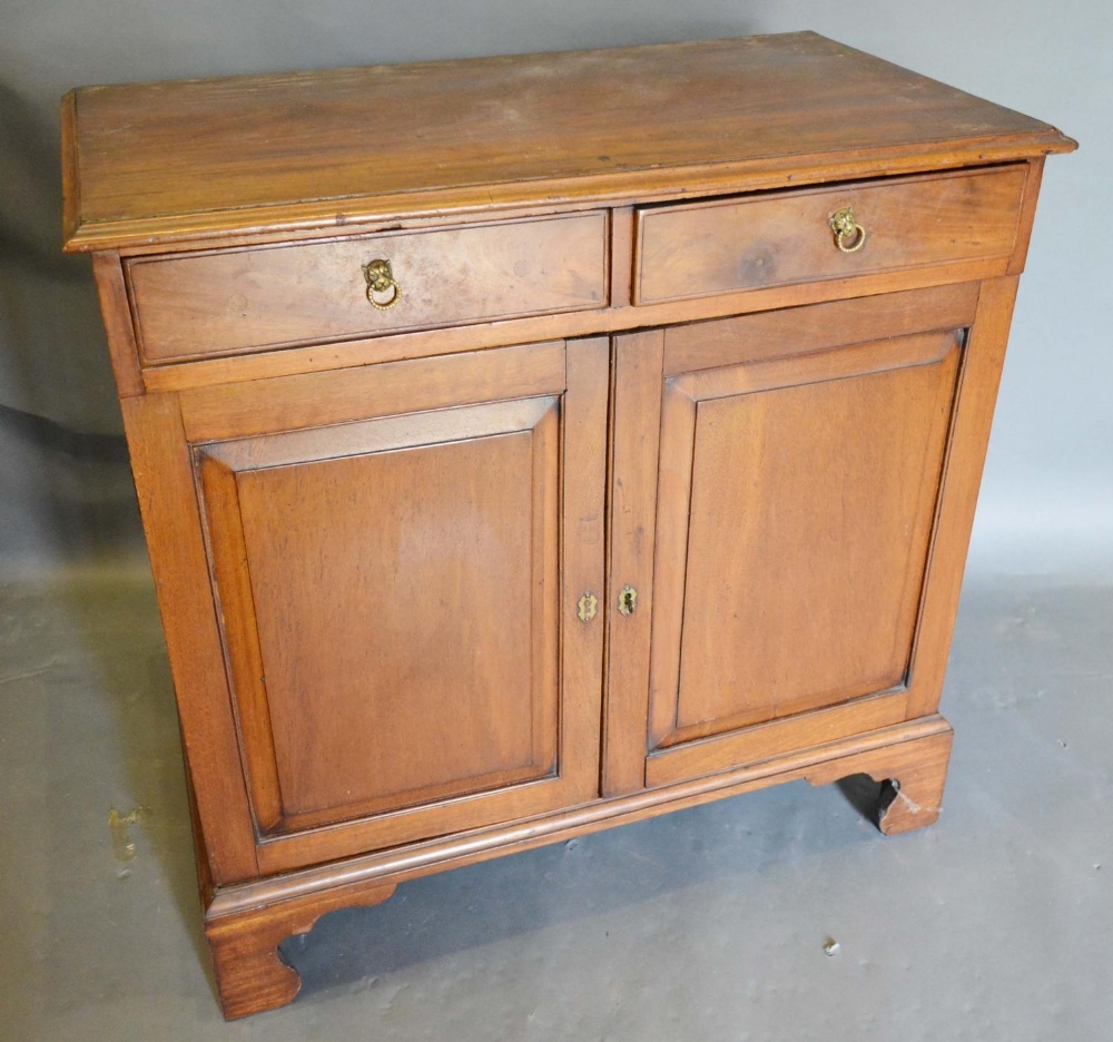 A 19th Century Mahogany Side Cabinet, the moulded top above two drawers and two moulded doors raised