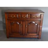 A George III Style Dresser Base with three drawers above two arched doors flanked by stiles, 106cm