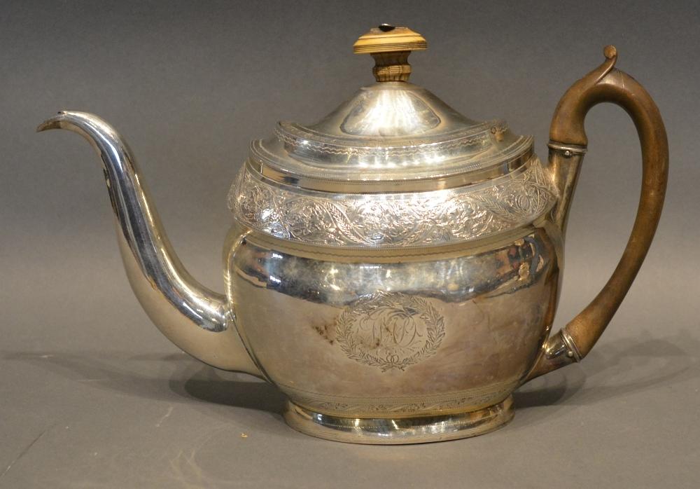 A George III Silver Teapot With Engraved Decoration and with shaped handle, London 1802, makers mark