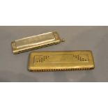 A Hohner The Super Chromonica Harmonica, together with another similar brass cased harmonica