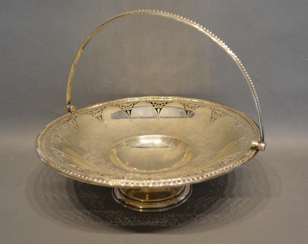 A Victorian Sheffield Silver Fruit Basket with pierced and engraved decoration upon a shaped