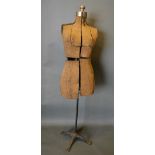 An Early Tailors Dummy with wrought iron stand, 150cm tall